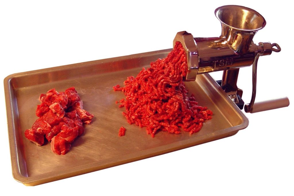 cuts of raw meat and beef in a meat grinder