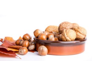 autumn nuts fall leaves in brown bowl white background nutrients from plants unsaturated fat