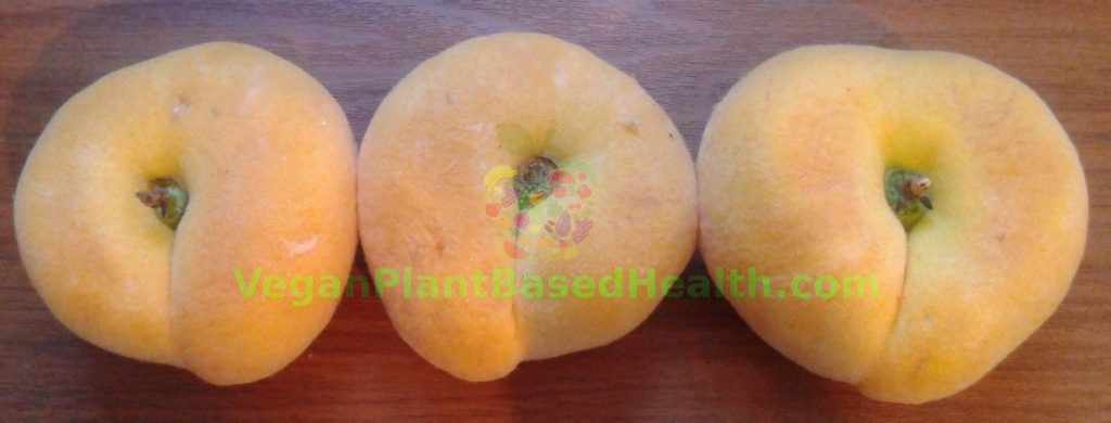 three orange peaches wood background doughnut saturn flat